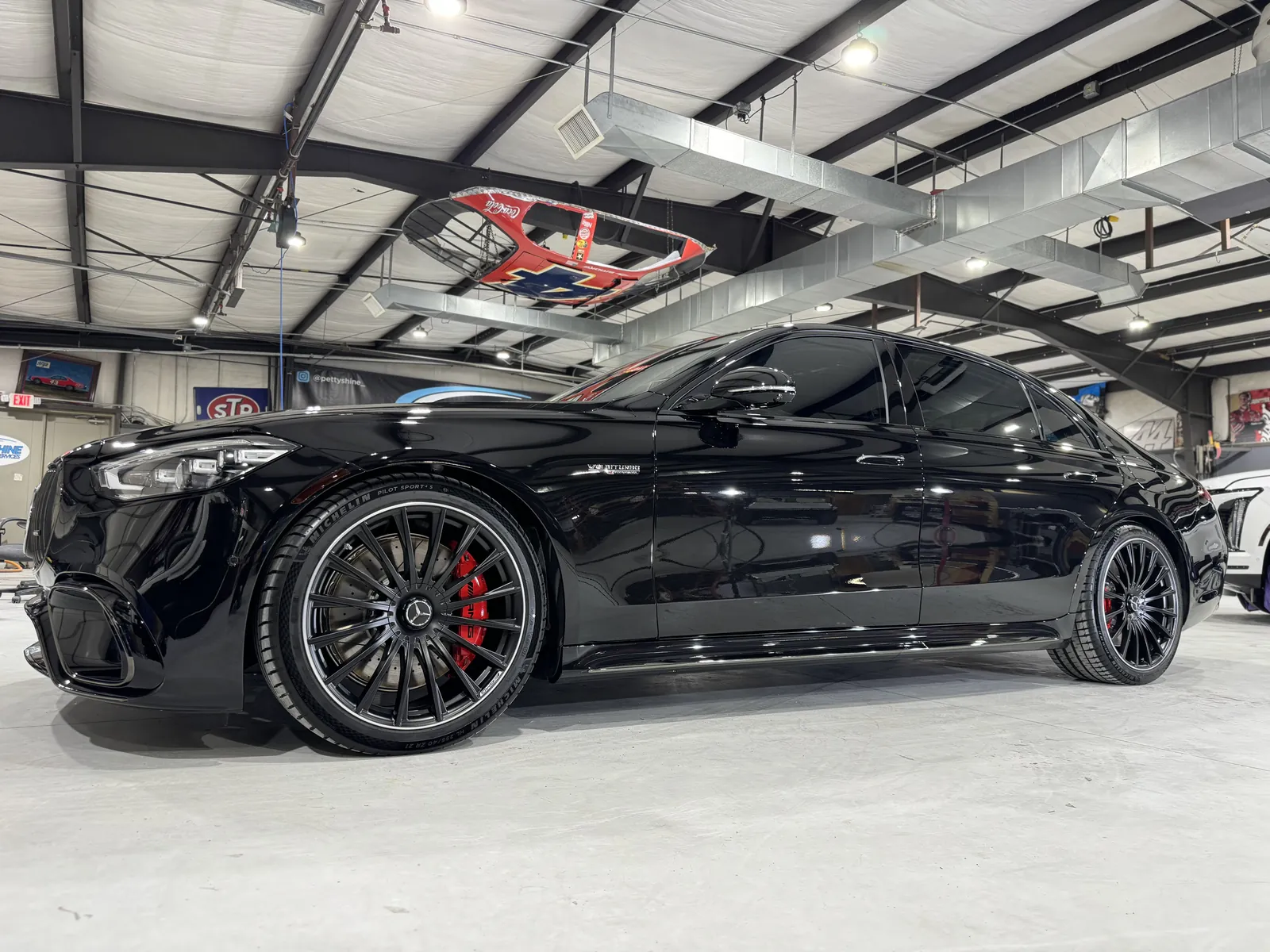 Black Mercedes-AMG with red calipers inside the Petty Shine shop